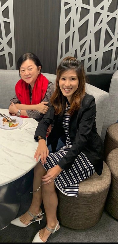 Gillian seated beside a client at a gathering
